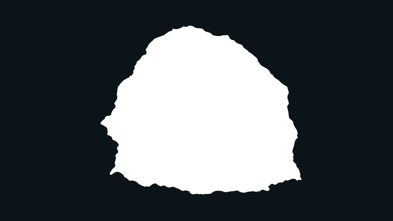 The silhouette of a coastal rock arch framing the view